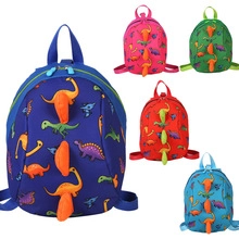 Detail view of colorful cartoon dinosaur backpacks featuring 3D sponge fins and vibrant prints