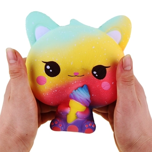 Close-up of rainbow gradient cat squishy toy holding an ice cream cone in soft PU material