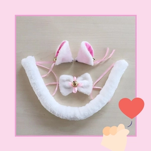 Detailed view of pink and white plush cat ear headbands, bow tie collar, and a long furry tail
