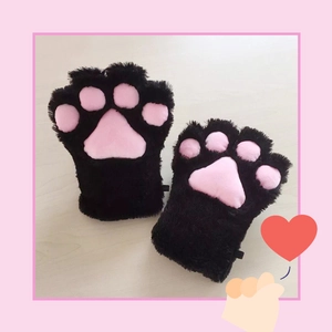 Cute black plush cat paw cosplay gloves with pink pads on light wood background