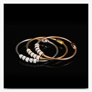 Detail of 3mm snake bone chain bracelets in silver, gold, and rose gold with rhinestones