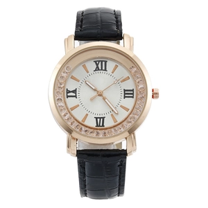 Close-up of white dial with Roman numerals and rhinestone bezel on black leather watch