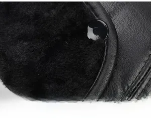 Detailed close-up of warm faux fur lining and black leather texture on a winter cap