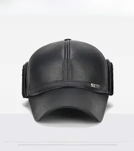 Close-up of black leather baseball cap with ear flaps and embossed sports metal logo