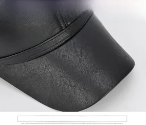 Detailed close-up of premium black leather baseball cap brim with fine lychee texture
