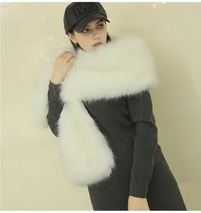 Detailed texture of white faux fox fur shawl wrap worn by model for winter evening wear