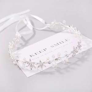 Elegant bridal hair vine with silver crystals and pearls on white ribbons