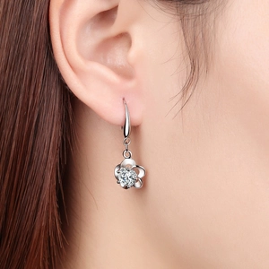 Elegant silver flower earrings with clear zircon center on female model close-up shot