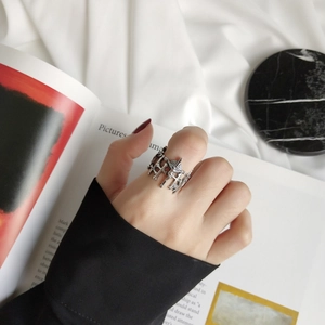 Detail shot of vintage 925 sterling silver cross ring worn on finger with gothic relief