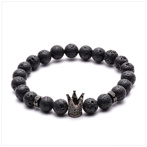Macro detail of 8mm black lava stone beads and micro-pave crown charm on men's bracelet