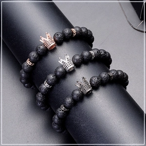 Detail of 8mm lava stone beads with micro-pave crown charms in rose gold, silver, and black