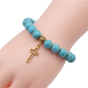 Turquoise bead bracelet with vintage gold cross charm pendant and marbled texture