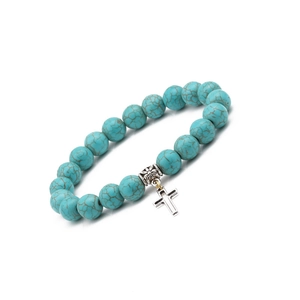 Detail of 10mm turquoise beaded bracelet with silver cross pendant and floral charm