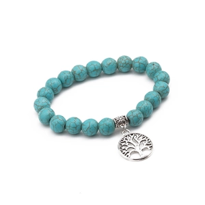 Detailed shot of 10mm turquoise beaded bracelet with silver Tree of Life charm pendant