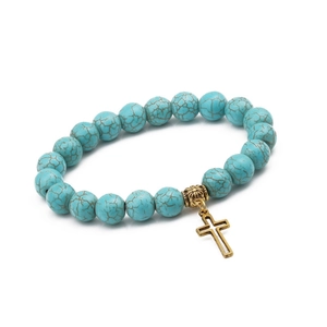 Close-up of 10mm turquoise beaded bracelet with an antique gold cross pendant