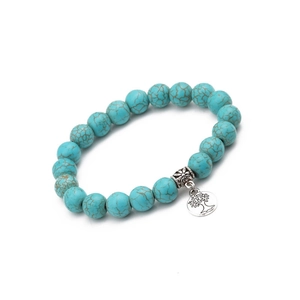 Detail of bohemian turquoise beaded bracelet featuring a silver tree of life charm