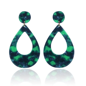 Detailed view of green teardrop earrings with acetate marble texture and gold accents