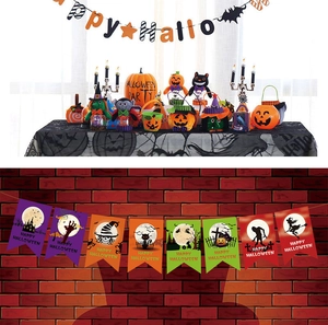 Close-up of Halloween party set with Happy Halloween banner and orange pumpkin buckets