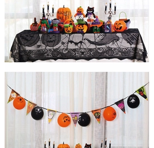 Halloween party scene with pumpkin banners, spooky dolls and black lace tablecloth décor