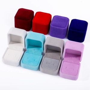 Multiple colorful velvet jewelry boxes for rings and earrings shown in an organized layout