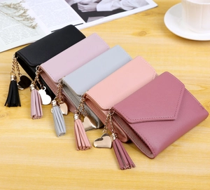 Detail of short wallets featuring tassel and heart pendants in various colors