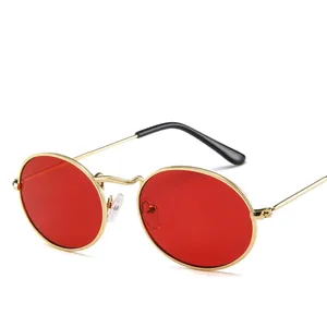 Retro small oval sunglasses with gold metal frame and vibrant red lenses for men and women