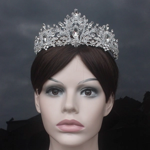 Exquisite bridal tiara featuring leaf-shaped crystals and rhinestones on a mannequin