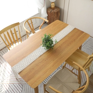 American country style handmade crochet table runner on a light wood dining table