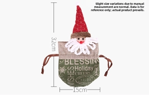 Detail of green linen Christmas gift bag with Santa Claus head and 32x15cm dimensions