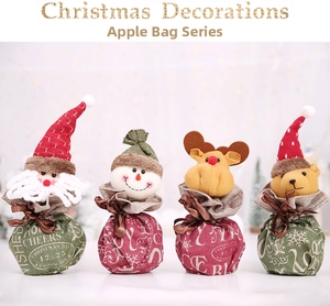 Detailed view of four Christmas gift bags featuring plush Santa, Snowman, Deer and Bear