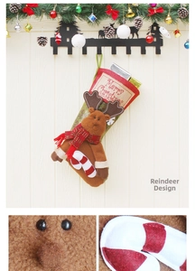 Detail of plush reindeer Christmas stocking with Merry Christmas patch on wood background