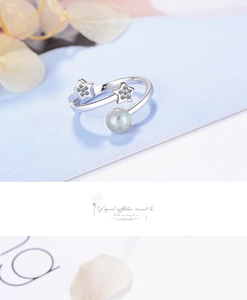 Macro shot of silver star ring with grey moonlight stone and sparkling crystals detail