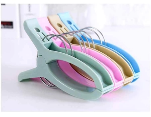 Close-up of colorful large plastic windproof laundry clips with metal rings in 4 colors
