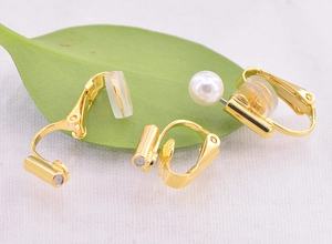 Detailed view of gold U-shaped earring converter with soft silicone pads and pearl accents