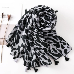 Detail of classic black and white leopard print scarf with delicate fringe tassels