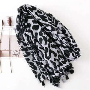 Detail shot of leopard print scarf with small fringe tassels and a minimalist aesthetic