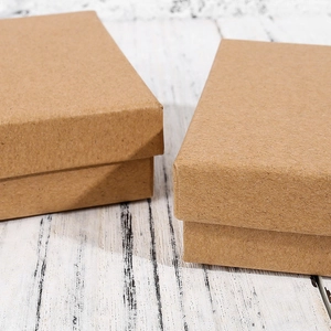 Macro shot of dark brown kraft paper jewelry gift box with natural fiber texture