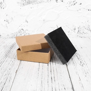 Close-up of square kraft paper jewelry box with black sponge insert for rings and necklaces