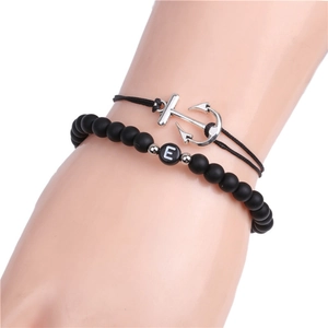 Detail of 6mm black matte bead bracelet with E letter charm and woven anchor cord
