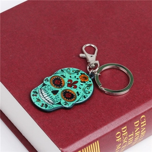 Creative turquoise sugar skull acrylic keychain with vibrant floral patterns and lobster clasp