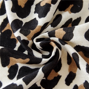 Close-up of leopard print scarf fabric showing detailed plain weave and soft texture