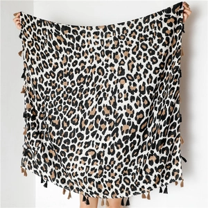 Detailed view of the leopard print scarf featuring bicolor tassels and cotton linen fabric