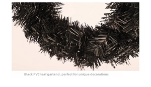 Macro close-up of the dense black PVC needle-like leaves on the decorative festive wreath