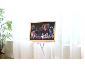 Framed Singapore city skyline scratch art with colorful fireworks on a white table