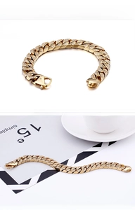 Detail of gold Cuban link bracelet with iced-out clear zircons and lobster clasp