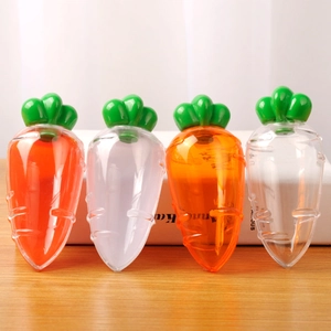 Carrot-shaped plastic candy storage boxes in four colors on a wooden table