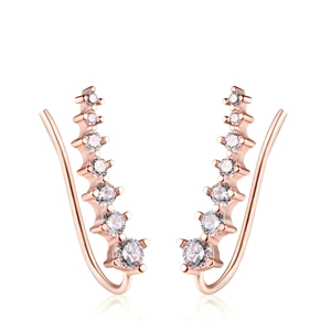 Detail of rose gold ear climbers with gradient round cubic zirconia in prong setting