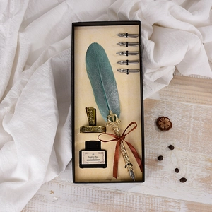 Vintage quill pen set with teal feather, ink bottle and 5 nibs in a black gift box