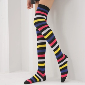 Detail view of colorful striped over-the-knee high socks in rainbow knit cotton fabric