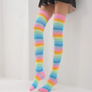 Close-up of rainbow striped over-knee socks with elastic knit texture on a model